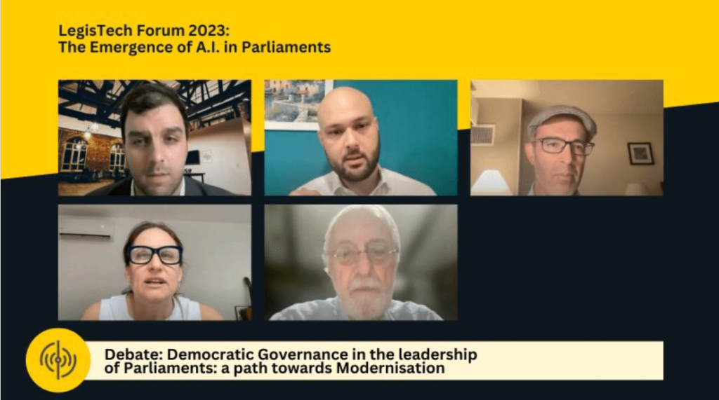 Captura de tela de uma conferência virtual do LegisTech Forum 2023, intitulada “The Emergence of A.I. in Parliaments”. Cinco participantes discutem a governança democrática e a modernização dos parlamentos. Jonas Gomes aparece na linha superior, ao centro, usando camisa social clara, contribuindo para o debate.